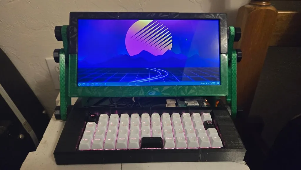 3D-printed cyberdeck: a portable Raspberry Pi computer with a green marbled frame, widescreen display, and mechanical keyboard